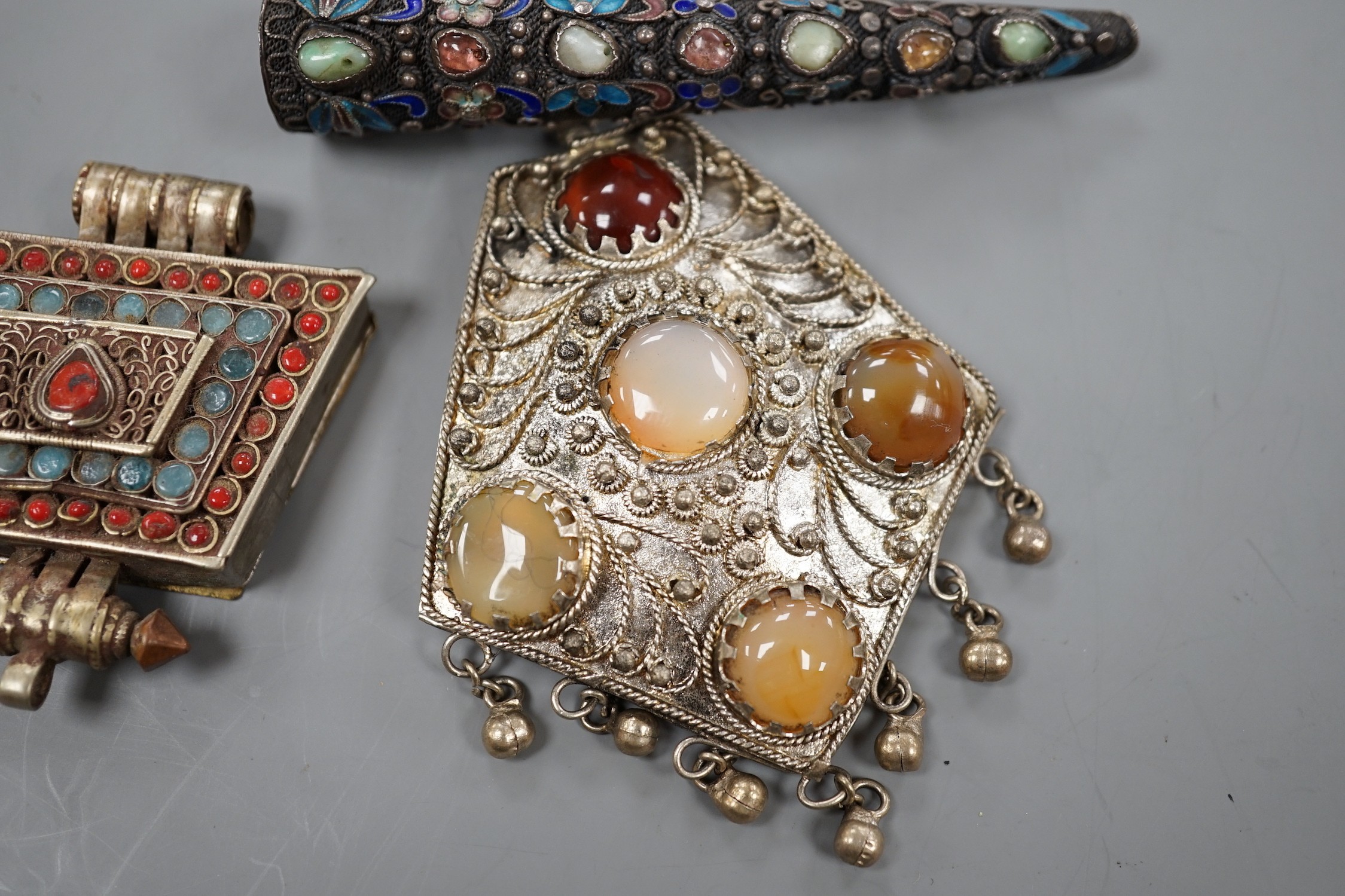 A Chinese filigree white metal, hardstone and enamel set nail guard, 86mm, together with two other Middle Eastern items.